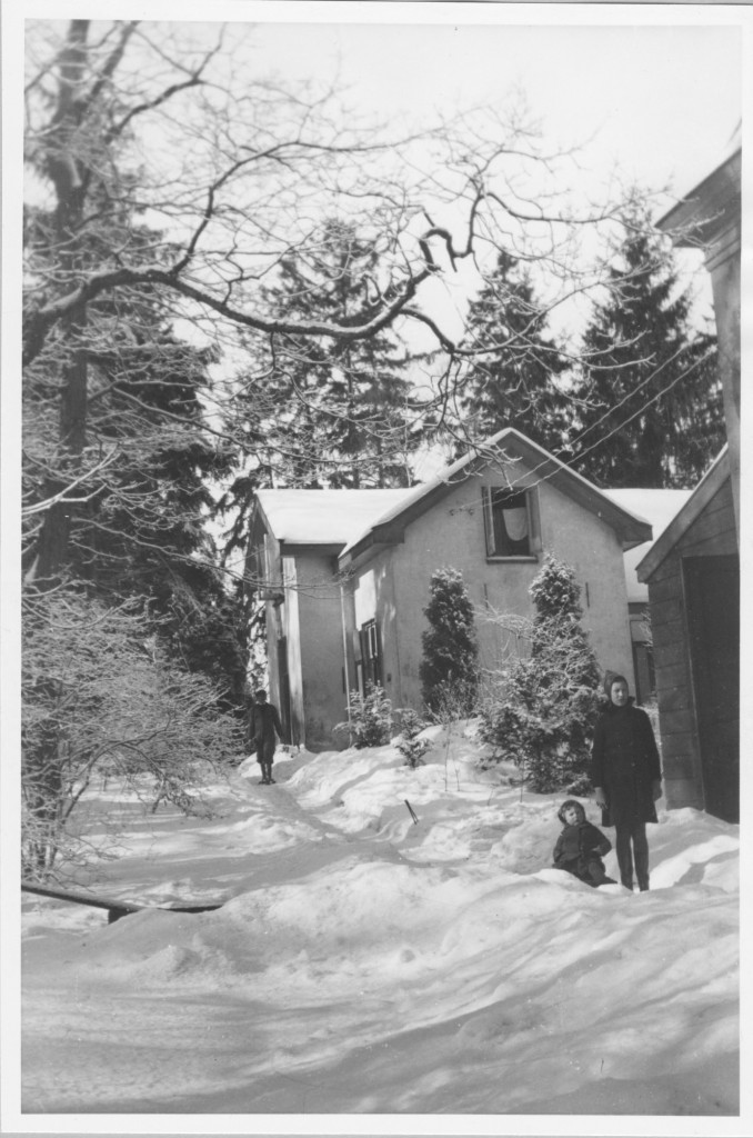 De koetsierswoning met links een deel van het oude koetshuis. De kinderen Verschoor in de sneeuw met op de achtergrond hun vader, aanvankelijk chauffeur later concierge van het huis.